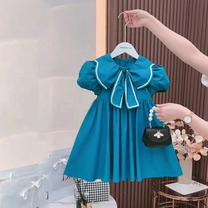 Vestido Infantil “Princesa Azul” – Mangas Bufantes e Laço Floral